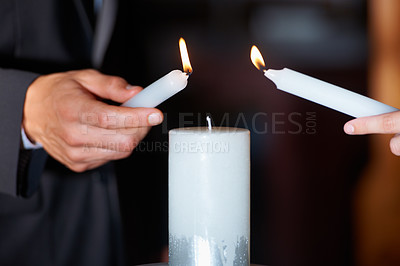Buy stock photo Closeup shot of a couple lighting candles during their wedding ceremony