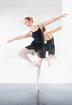 Buy stock photo Ballerina, ballet and woman is dancing in class, young dancer in rehearsal with art and grace at studio. Female person in pointe pose, balance and training for performance with creativity and fitness