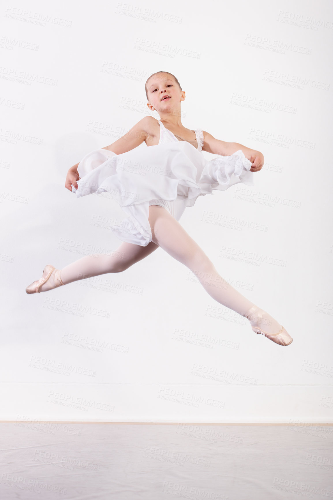 Buy stock photo Portrait, air and girl in ballet studio with pose, balance and performance dance class in tutu. Jump, talent and young ballerina dancer with pride, confidence and creative child at learning academy.