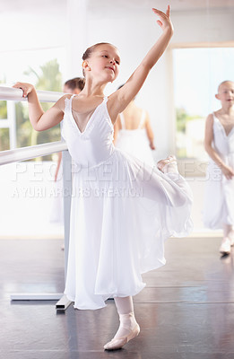 Buy stock photo Girl ballerina pose at barre, ballet and dance class with young dancer learning balance and art at studio. Female child in lesson at academy, creativity with fitness and training, elegance and focus