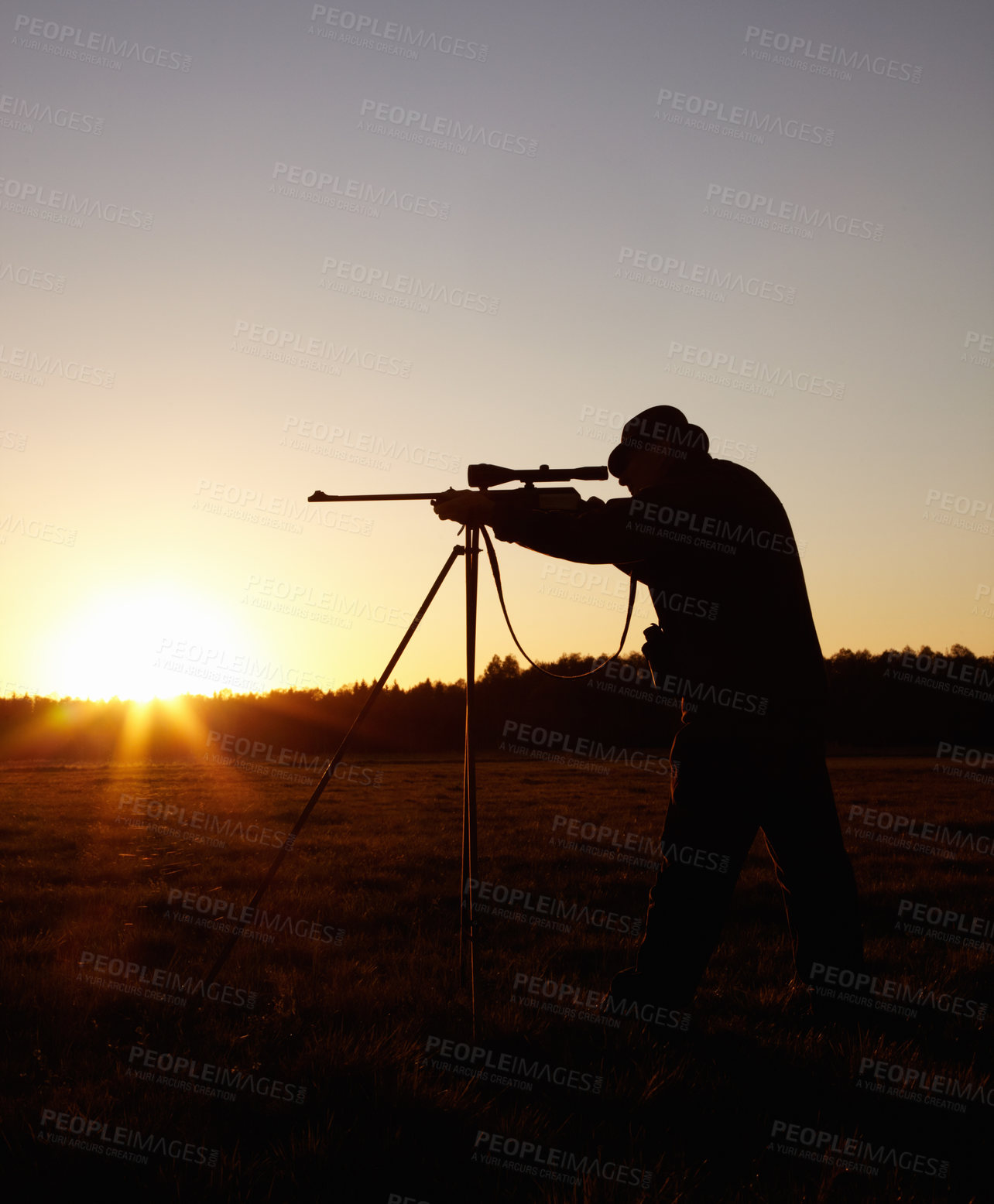 Buy stock photo Hunting at sunset, man with rifle stand in nature to hunt game for sport on safari adventure. Sky, silhouette and hunter with gun, focus on target and evening setting sun for shooting hobby in bush.