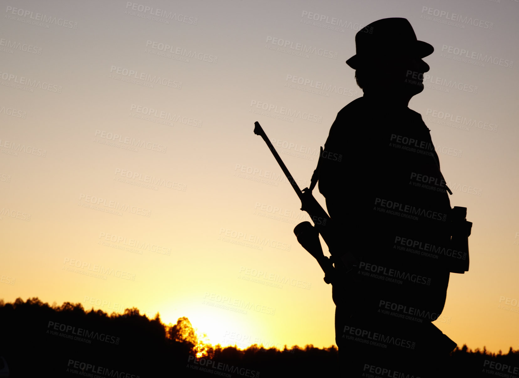 Buy stock photo Hunting at sunset, man with rifle and mockup in nature to hunt game for sport hobby on safari adventure. African sky, silhouette and mock up space, hunter with gun in bush and evening setting sun.