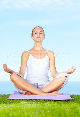 Buy stock photo An attractive young woman meditating outside