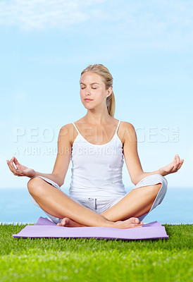 Buy stock photo Woman, lotus pose and meditation in park for peace, calm and mental health or wellness and mindfulness. Young and zen person relax with outdoor yoga, spiritual care and chakra on blue sky background
