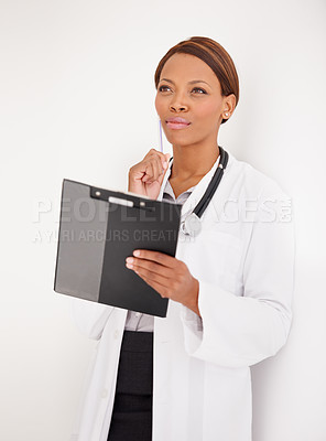 Buy stock photo Woman, doctor thinking and healthcare charts for hospital schedule, management or results with solution or ideas. African person reading of medical checklist, clipboard or folder on a wall background