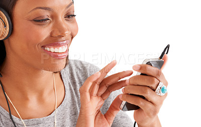 Buy stock photo Happy black woman, phone and headphones for music or audio streaming against a white studio background. Face of African female person on mobile smartphone app for sound track, playlist or podcast