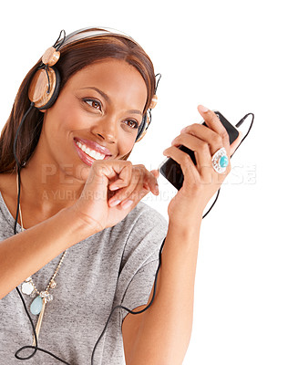 Buy stock photo Happy black woman, phone and headphones for podcast or audio streaming against a white studio background. Face of African female person on mobile smartphone app for sound track, playlist or music