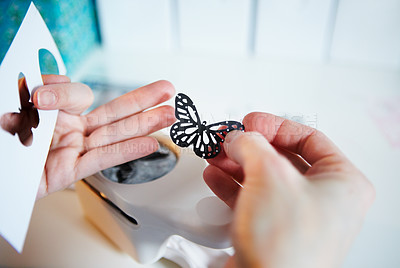 Buy stock photo Cropped shot of a woman's hands holding a punched out paper butterfly