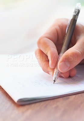 Buy stock photo Cropped shot of a businessman writing on a notepad