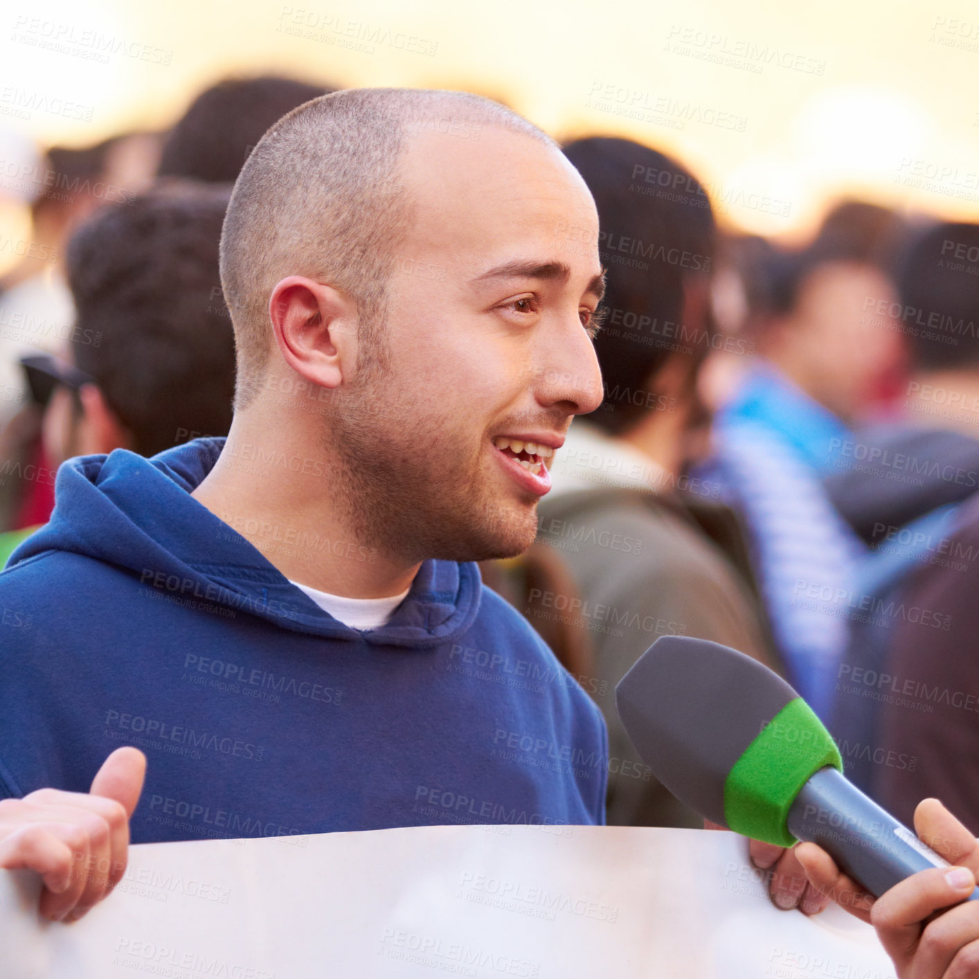 Buy stock photo Shot of a protestor being interviewed at a rally