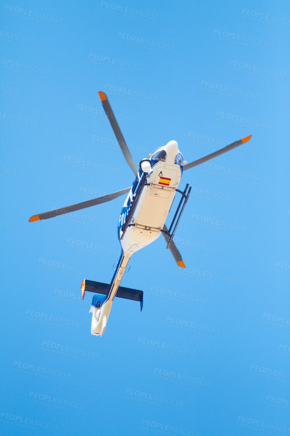 Buy stock photo Low angle shot of a police helicopter in the sky