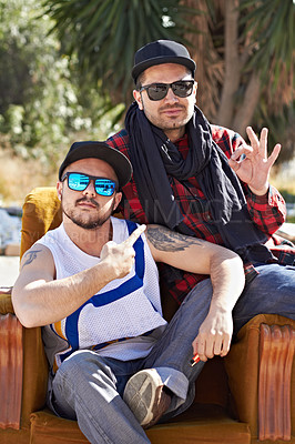 Buy stock photo Urban, sign and men with hip hop style on chair in nature for unique lifestyle. Fashion, stylish and portrait of cool, gangster and street friends with sunglasses, ok hand and culture in neighborhood