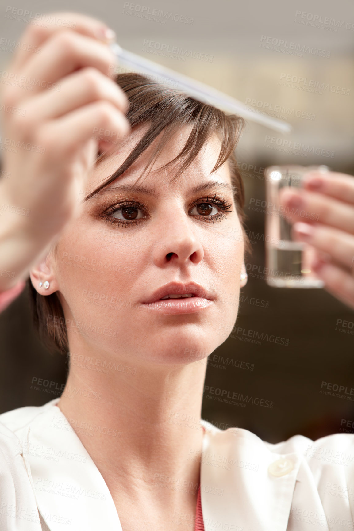 Buy stock photo Shot of an attractive scientist examining a fluid-filled beaker