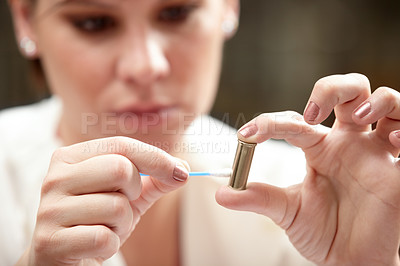 Buy stock photo A forensic scientist applying an ear bud to a bullet 