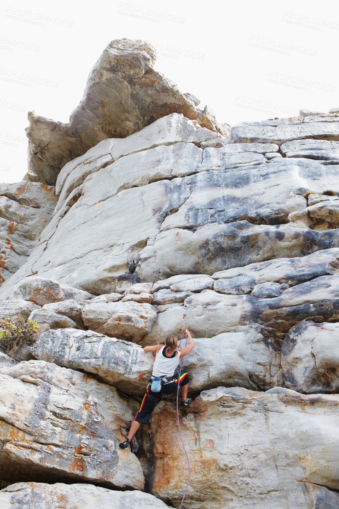 Buy stock photo Woman, rock climbing and mountain or rope explore for grip strength, stone cliff or sports challenge. Female person, boulder hill and gear for outdoor peak safety or healthy fear, risk or fit danger