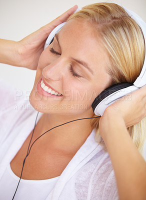 Buy stock photo Woman, eyes closed and smile with headphones for listening in closeup for music, podcast or radio. Person, calm or peaceful expression on face for audio, song or streaming service in home on internet