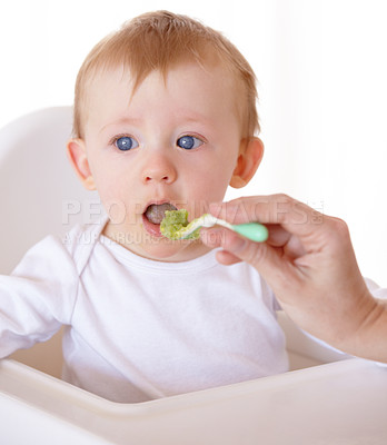 Buy stock photo Sweet, spoon and baby eating vegetables in feeding chair in a studio for health and nutrition. Cute, natural and boy newborn, child or kid enjoying a meal for wellness diet by white background.