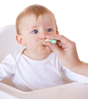 Buy stock photo Cute, spoon and baby eating vegetables in feeding chair in a studio for health and nutrition. Sweet, natural and boy newborn, child or kid enjoying a meal for wellness diet by white background.