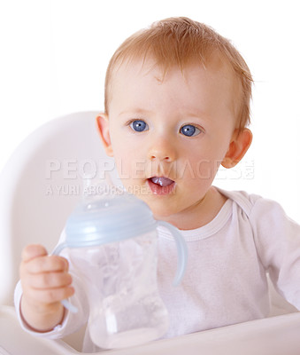 Buy stock photo An adorable baby boy holding up his baby bottle to be filled