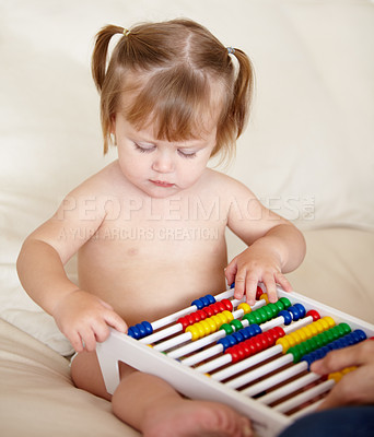 Buy stock photo Learning, child development and a girl baby with an abacus in the bedroom of a home for growth. Kids, education or math with an adorable and curious young toddler counting on a bed in an apartment