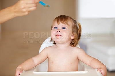 Buy stock photo Family, growth and a parent feeding her baby breakfast in the morning while in a home together for development. Children, food and a girl toddler eating with a healthy meal in an apartment kitchen