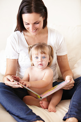 Buy stock photo Baby, mother and portrait or book on sofa with reading, relax and parenting in living room of home with smile. Family, woman and girl child with happiness on couch in lounge for development and love