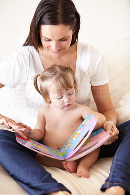 Buy stock photo Baby, mother and book or reading on sofa with learning, relax and parenting in living room of home with smile. Family, woman and girl child with happy on couch in lounge for development, love or care