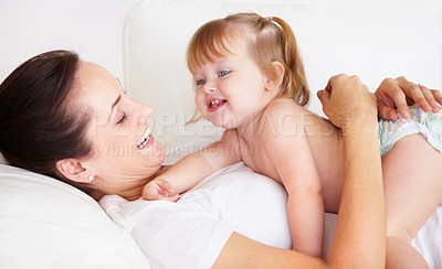 Buy stock photo Baby, mother and laughing or hug on sofa with playing, relax and parenting in living room of home with security. Family, woman and girl child with happiness on couch in lounge for development or love