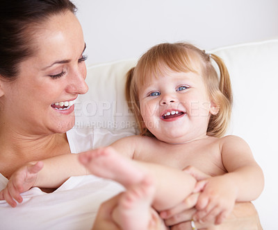 Buy stock photo Baby, mother and portrait or smile on sofa with playing, relax and parenting in living room with security. Family, woman and girl child with happiness on couch in lounge for development, love or care