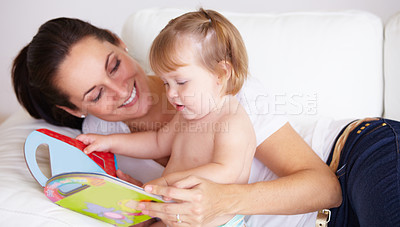 Buy stock photo Baby, mother and book or reading on sofa with learning, relax and parenting in living room of home with smile. Family, woman and girl child with happiness on couch in lounge for development and love