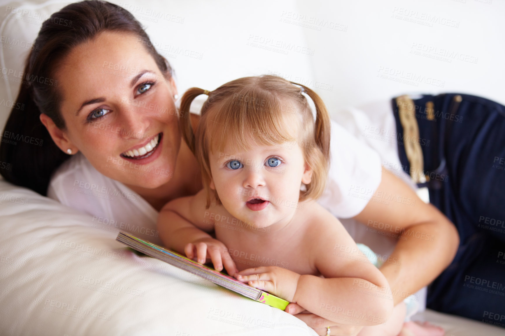 Buy stock photo Baby, mother and portrait or smile on sofa with children book, relax and parenting in living room of home. Family, woman and girl child with happiness on couch in lounge for development, love or care