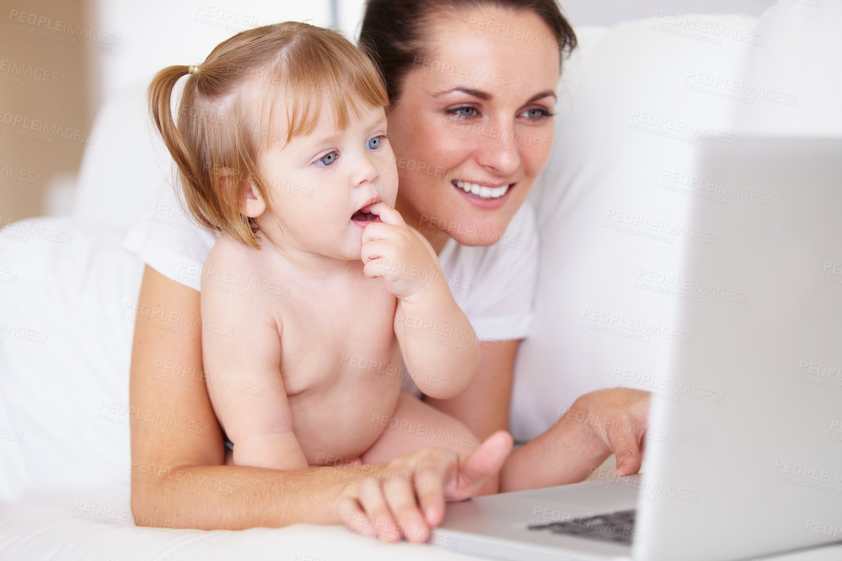 Buy stock photo Family, laptop for remote work with a mother and baby in the bedroom of a home together to multitask. Computer, freelance or childcare with a woman parent and her girl toddler on an apartment bed