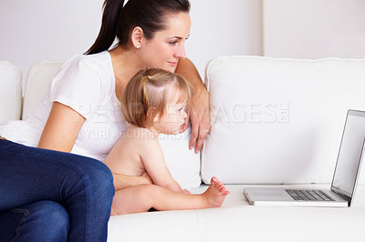Buy stock photo Family, laptop or streaming with a mom and baby on a sofa in the living room of a home for entertainment. Computer, movie or childcare with a woman parent and toddler girl in an apartment together