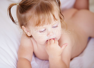 Buy stock photo Face, growth and child development with a baby in the bedroom to relax alone in the morning. Home, kids or youth and an adorable young infant girl on a bed with blankets for comfort in an apartment