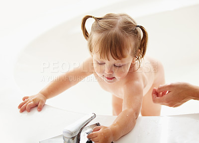 Buy stock photo Kids, cleaning and water with a baby in the bath for natural skincare, development or hygiene. Children, bathroom and a curious young toddler girl in a bathtub for health and wellness in her home