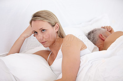 Buy stock photo Beautiful woman looking unhappy with her back to her husband in bed