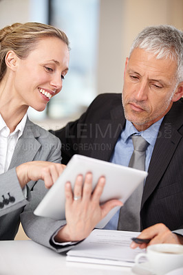Buy stock photo Businesswoman showing her colleague some information