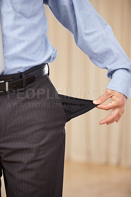 Buy stock photo A cropped image of a businessman turning out his pocket and showing that it is empty