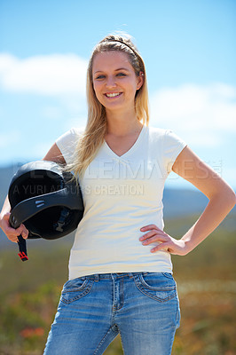 Buy stock photo Cropped shot of a beautiful young woman outdoors posing with a skydiving helmet under her arm