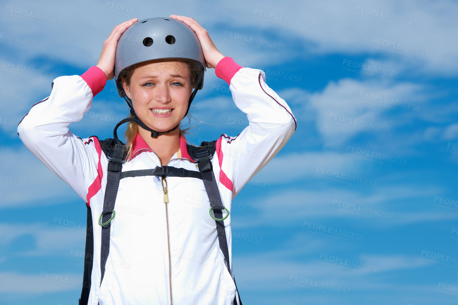 Buy stock photo Skydiving, worry and portrait of woman on adventure with helmet and anxiety or stress on sky background. Nervous, skydiver and face with fear at the start of stunt in countryside with safety gear