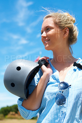 Buy stock photo Safety, helmet and woman on blue sky for adventure, outdoor and thinking in countryside with a smile. Happy, person and ready to start skydiving, stunt or risk danger with hardhat for security