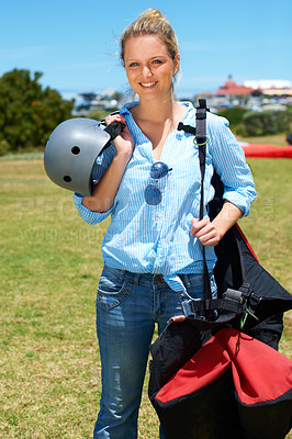 Buy stock photo Skydiving, portrait and woman outdoor for adventure with gear and helmet in countryside with a smile. Happy, person and skydiver ready to start, stunt or risk danger with equipment for security