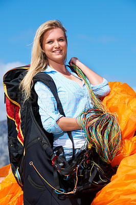 Buy stock photo Shot of a young woman getting ready to go paragliding