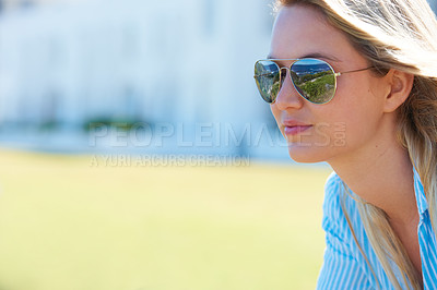 Buy stock photo Woman, face and smile outdoor with sunglasses for relax, peace and beach in summer for vacation or holiday. Person, happy and eyewear or shades by ocean or sea for scenery, adventure or carefree 