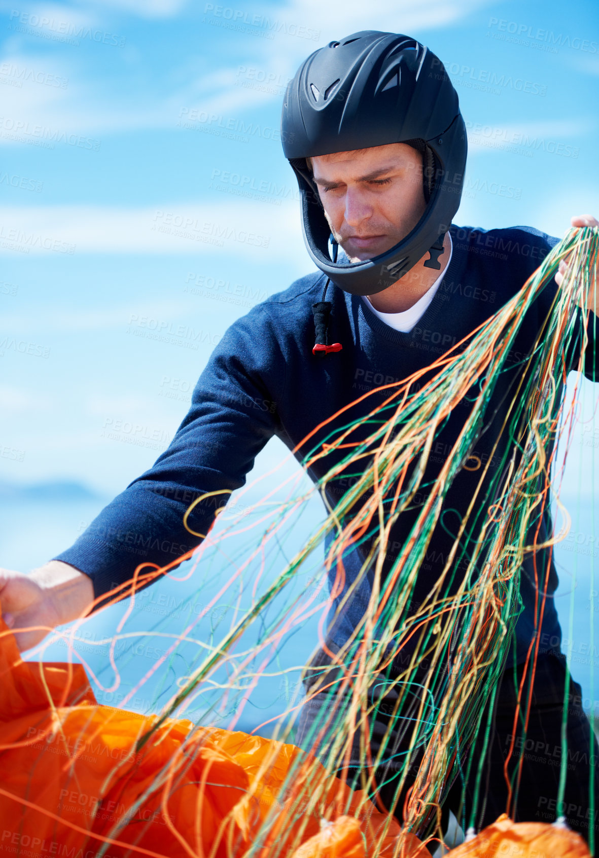 Buy stock photo Paragliding, parachute or man with strings in nature in preparation, exercise or health support. Young person, fitness or wellness for outdoor with safety harness, helmet or adventure in countryside