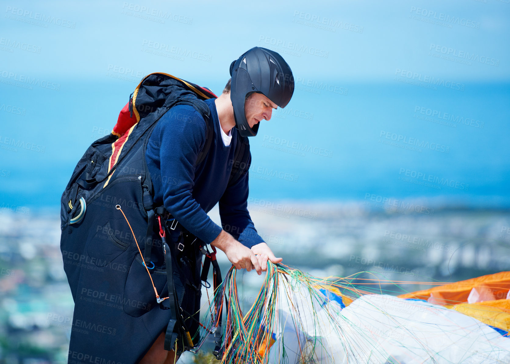 Buy stock photo Shot of a man getting ready to go paragliding