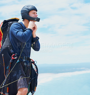 Buy stock photo Preparation, parachute or man with helmet for sport, safety or gear to exercise for health wellness. Sky mockup, equipment or fitness in nature for outdoor training, fearless or countryside adventure