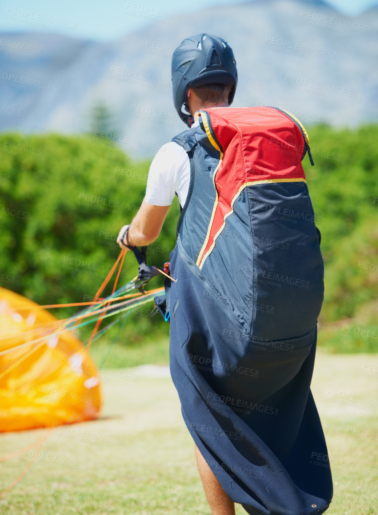 Buy stock photo Nature, man and parachute with ground for sport preparation, strings and training for paragliding exercise. Person, safety gear and helmet for outdoor fitness with toggle, fearless and countryside