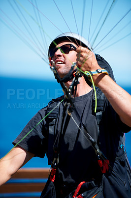 Buy stock photo Man, parachute and paragliding launch in air in nature, exercise and healthy adventure fof extreme sport. Person, glide or fearless in outdoor fitness for wellness, helmet or safety gear by blue sky 