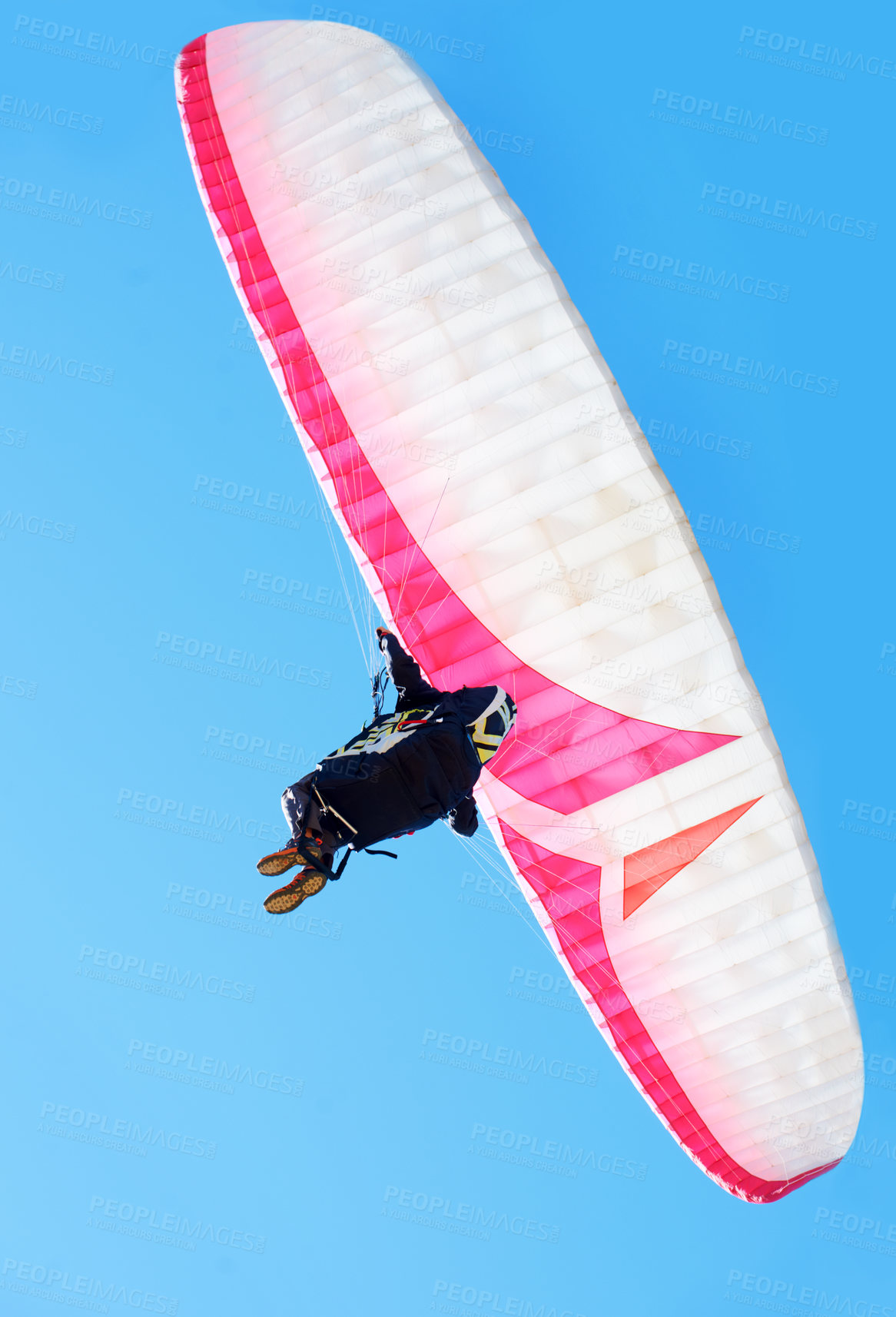 Buy stock photo Person, parachute or paragliding in air in nature, exercise or healthy adventure for extreme sport. Athlete, glide and fearless for outdoor fitness for wellness, below and safety gear by blue sky